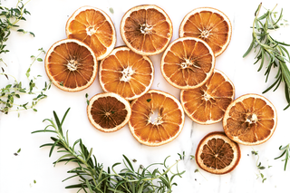 dried orange and rosemary on white background
